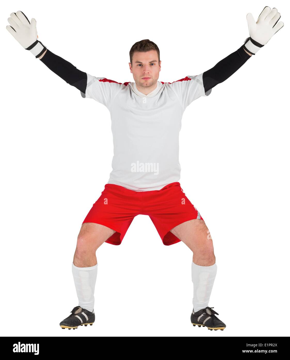 Goalkeeper in white ready to save Stock Photo