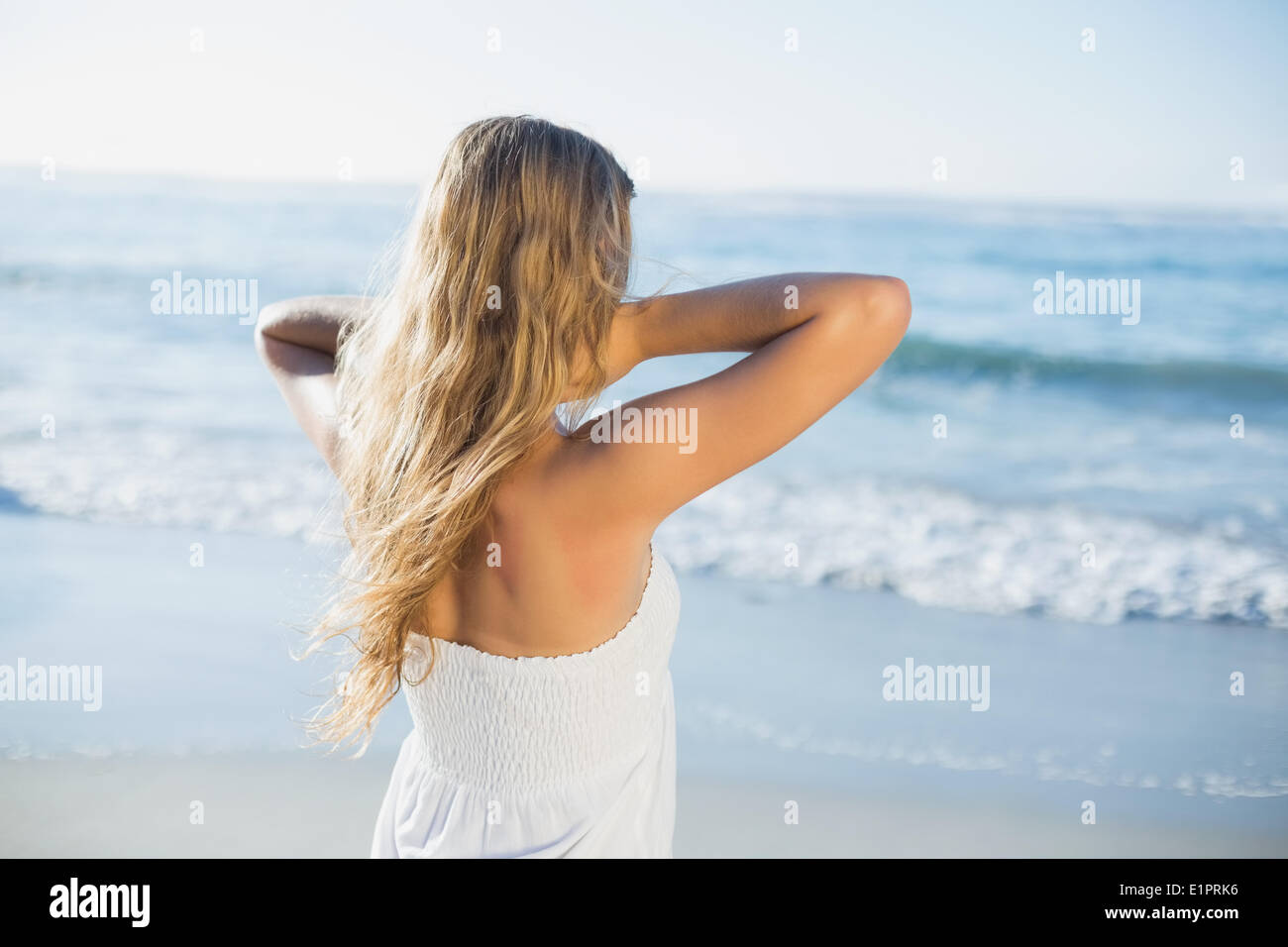 Beautiful blonde in white sundress on the beach Stock Photo - Alamy