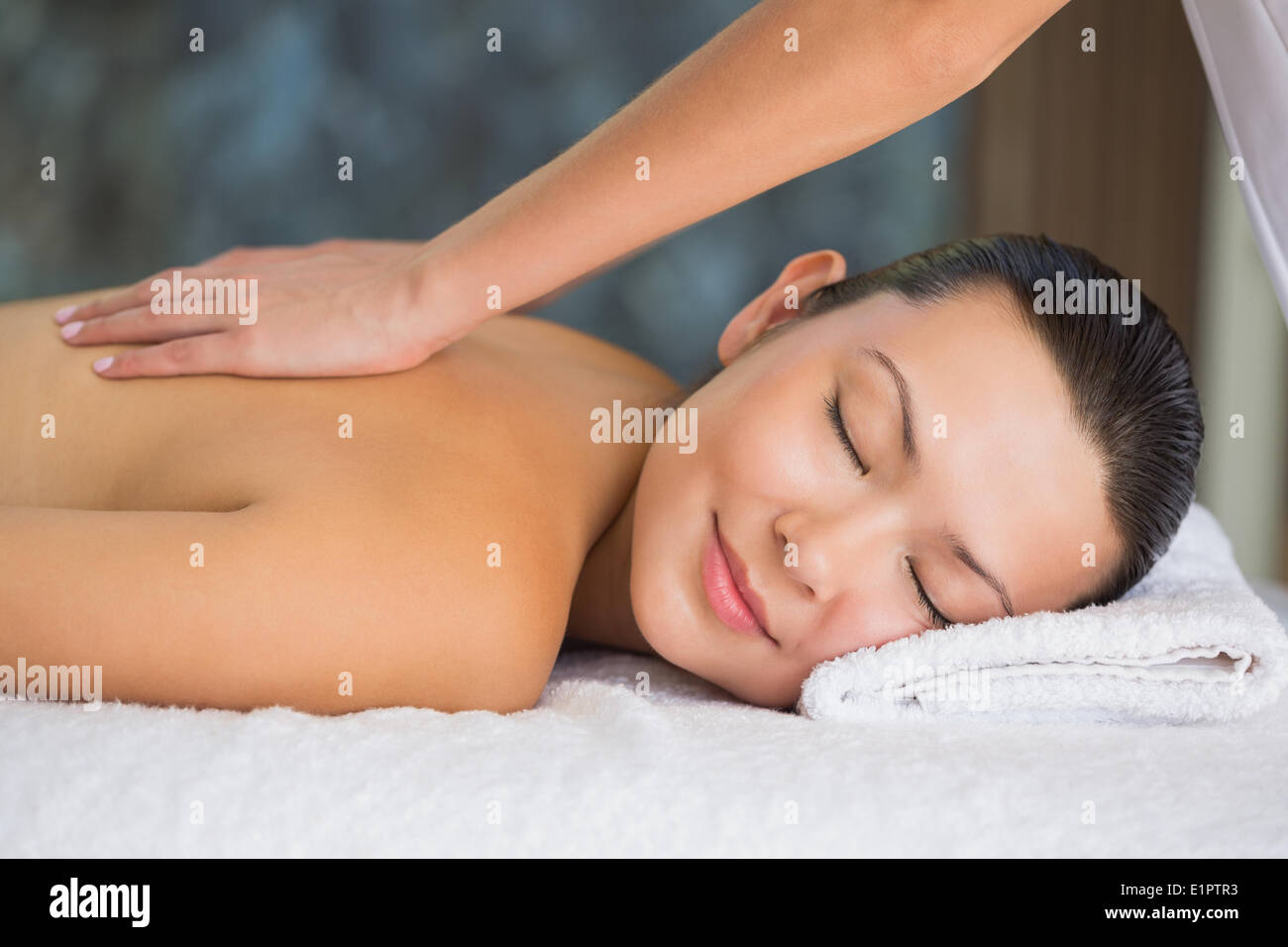 Smiling brunette enjoying a back massage Stock Photo