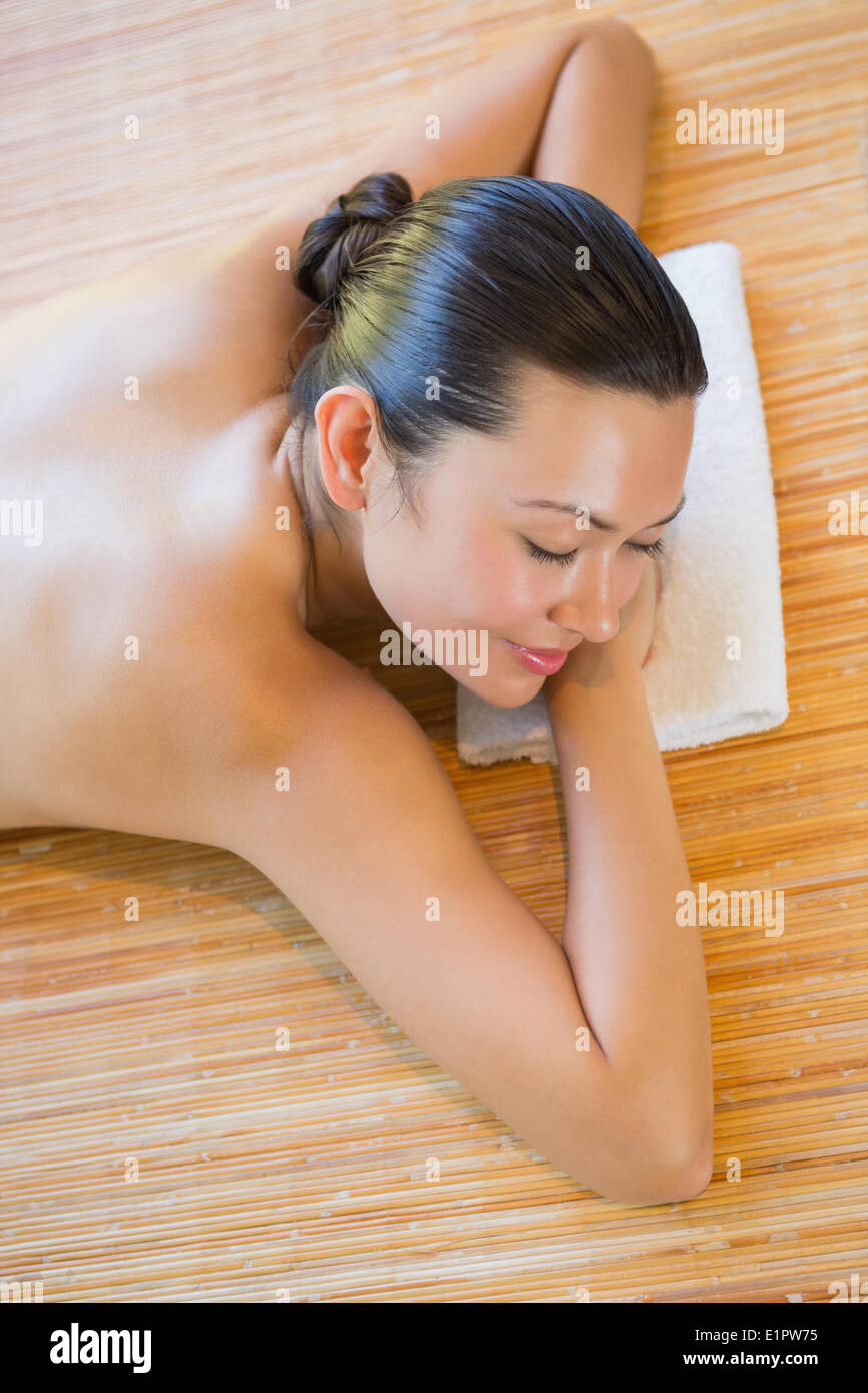 Smiling brunette relaxing on massage table Stock Photo
