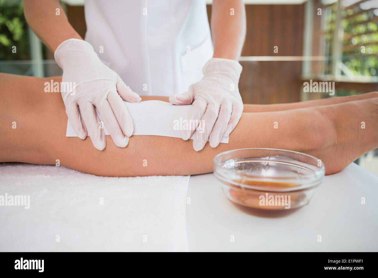 Woman getting her legs waxed by beauty therapist Stock Photo