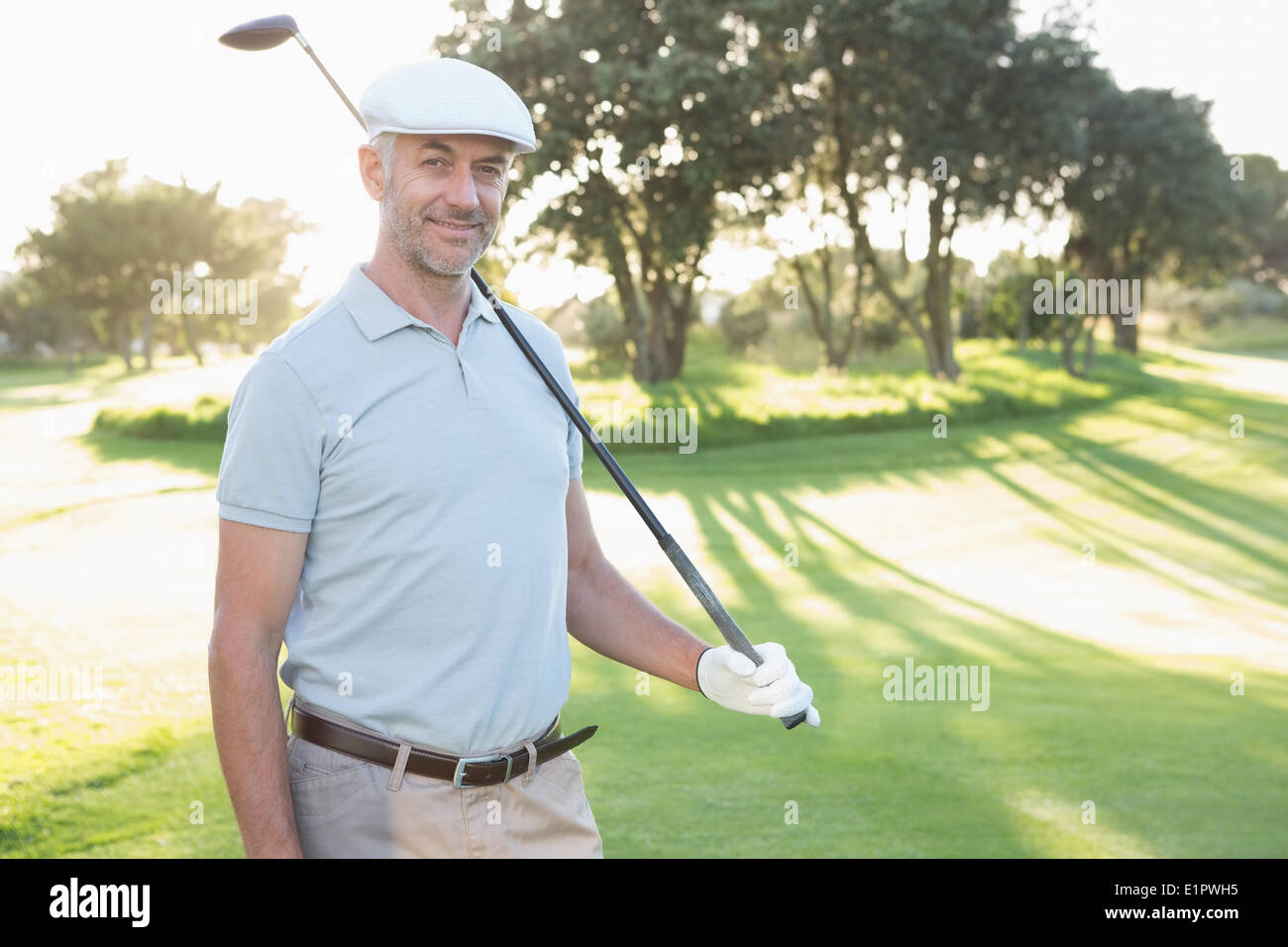 Smiling handsome golfer looking at camera Stock Photo