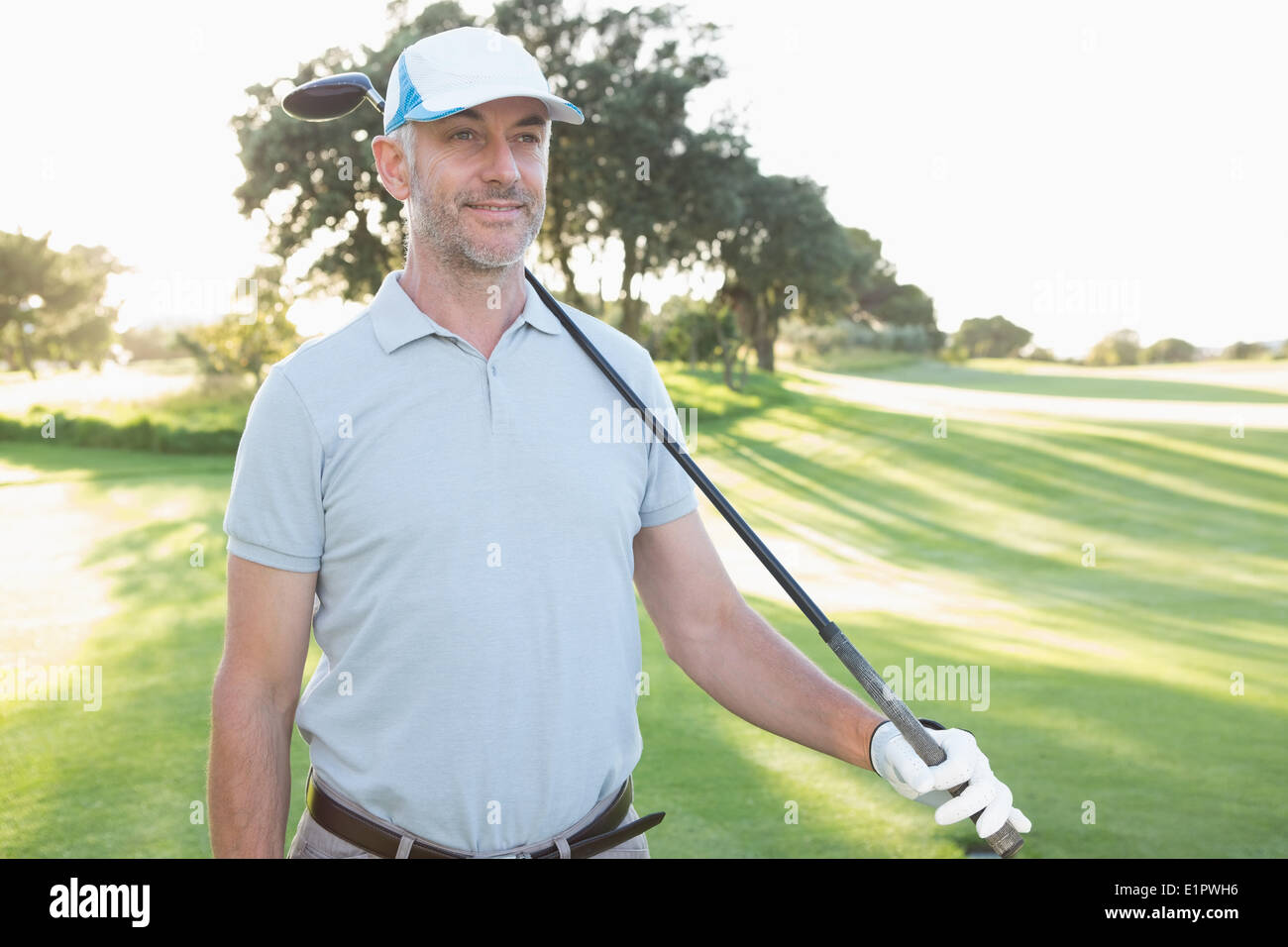 Smiling handsome golfer looking ahead Stock Photo