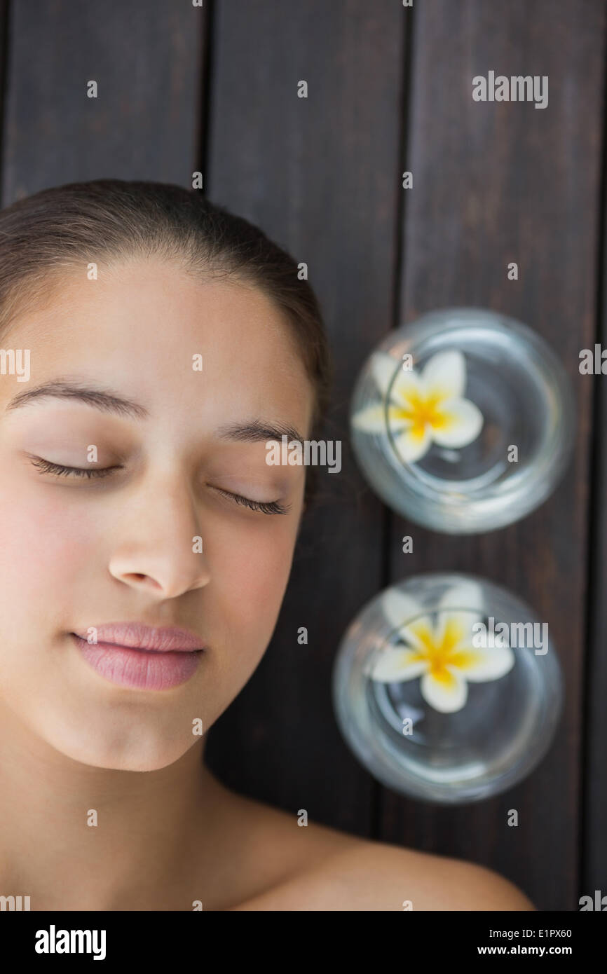 Peaceful brunette lying with eyes closed Stock Photo