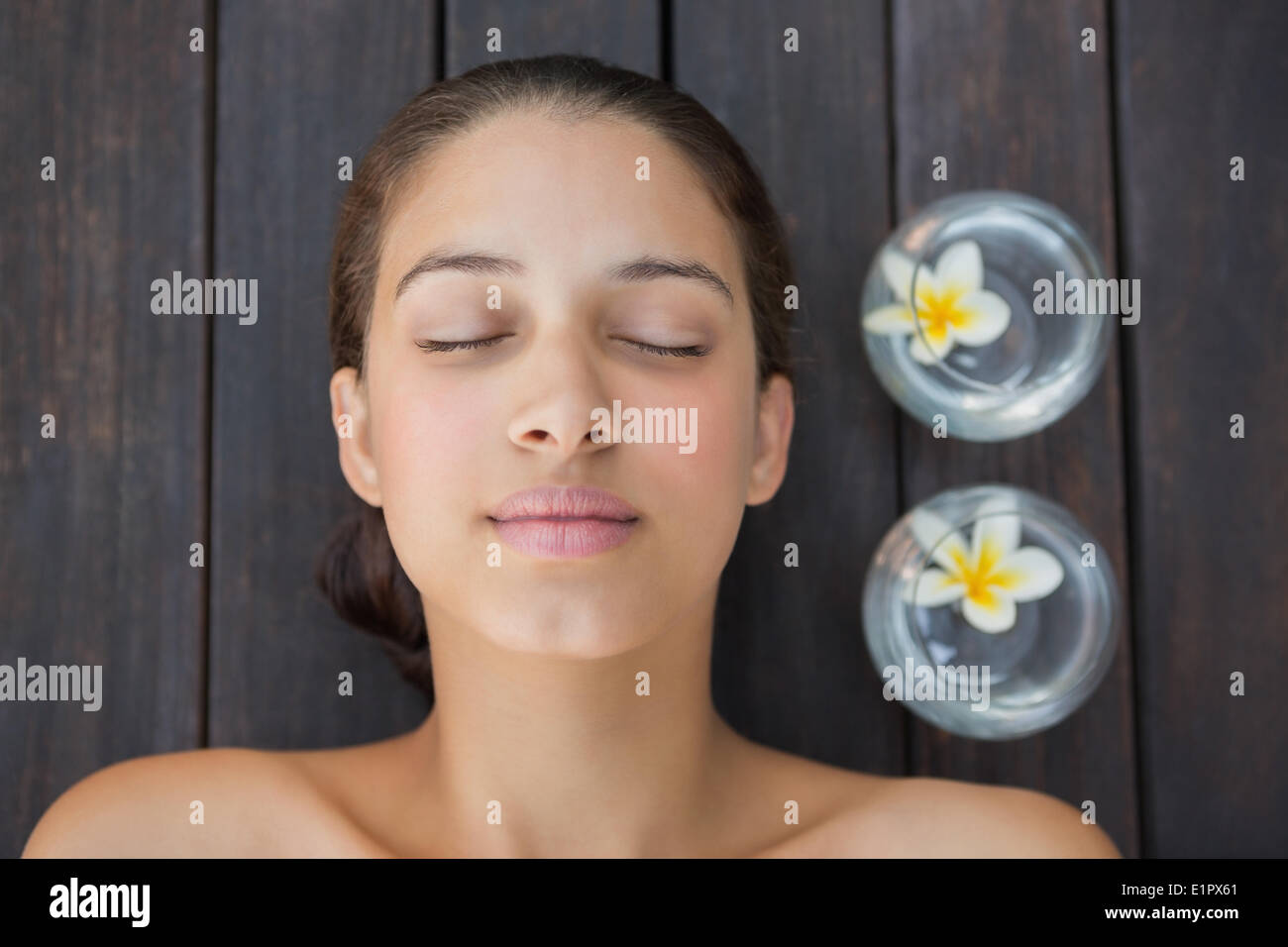 Peaceful brunette lying with eyes closed Stock Photo