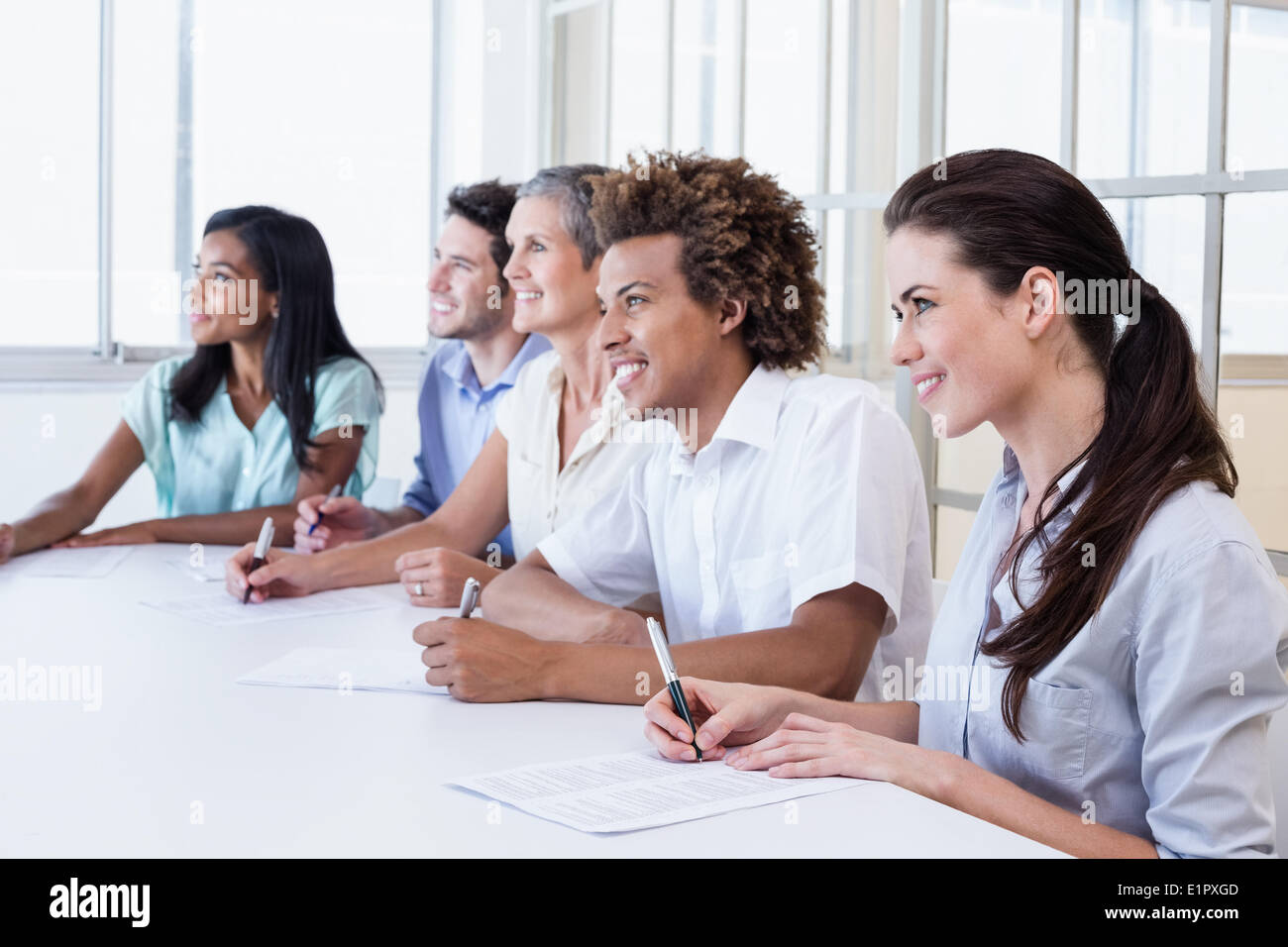 Casual business team taking notes in meeting Stock Photo - Alamy
