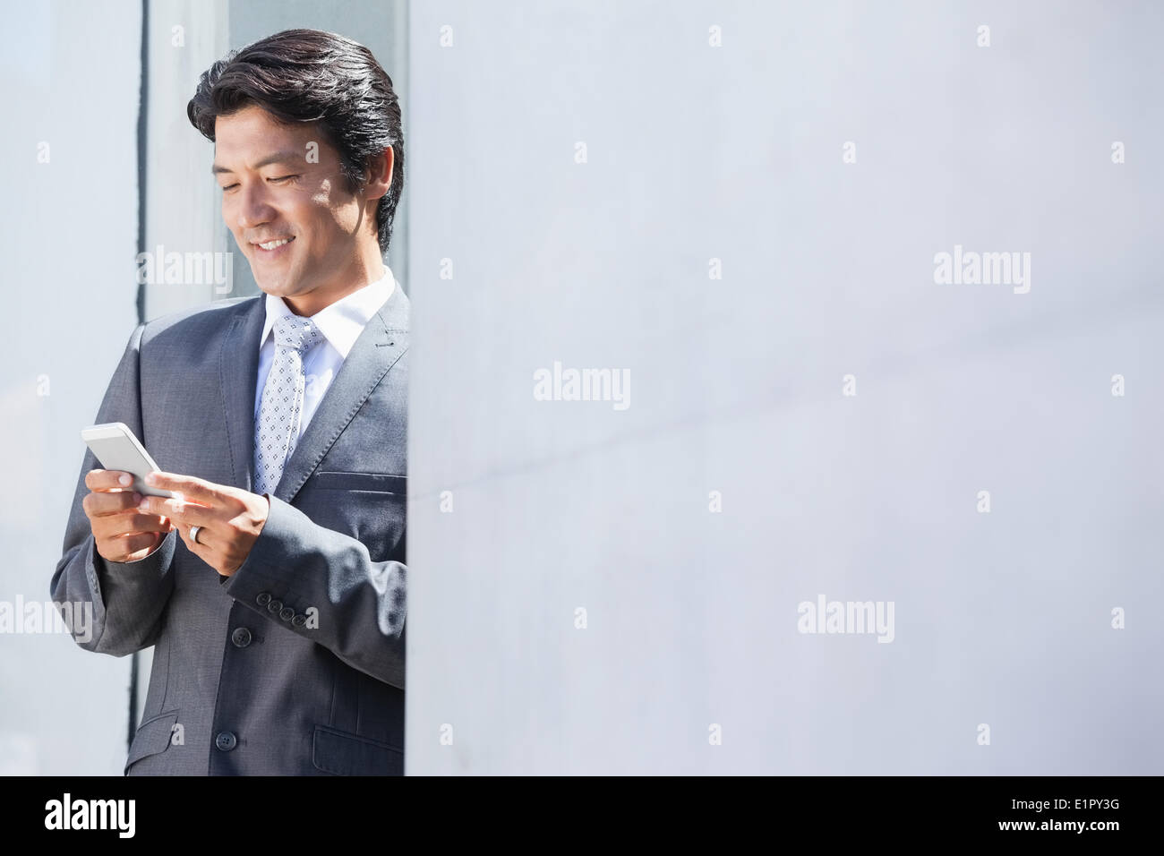 Asian businessman sending text message Stock Photo