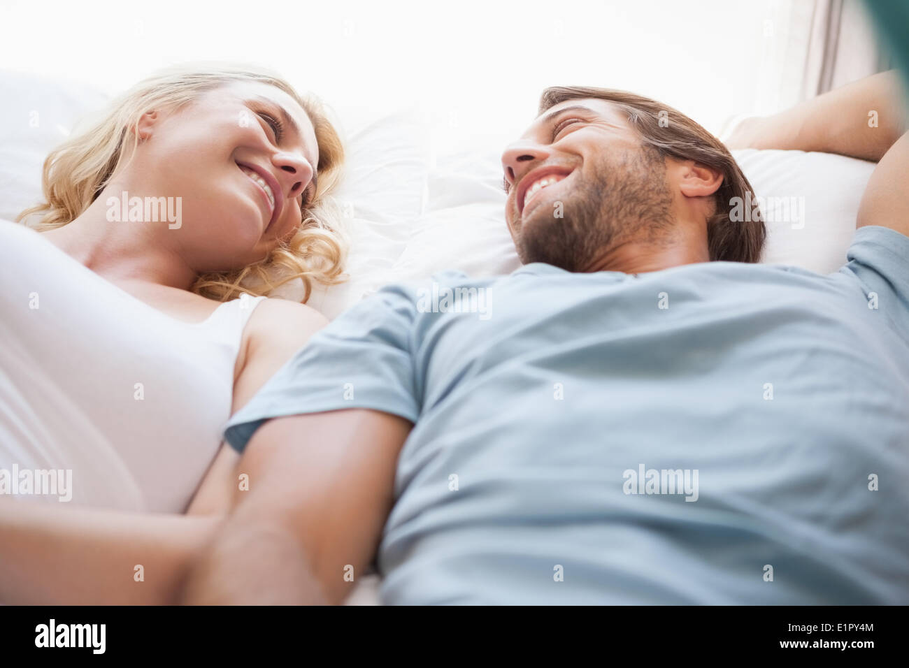 Cute couple lying on a bed Stock Photo