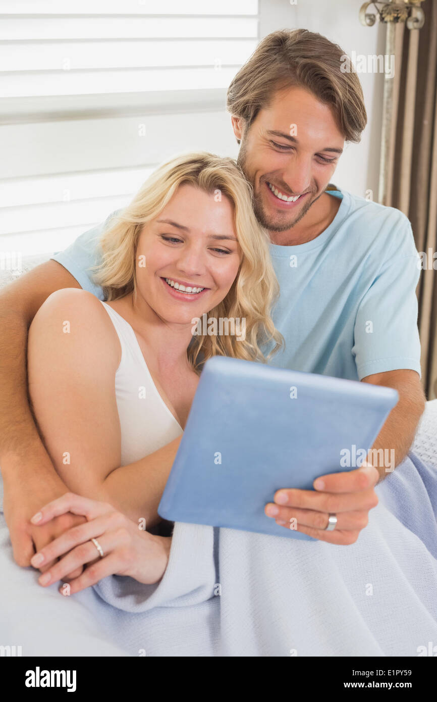Young couple using tablet pc on the couch Stock Photo