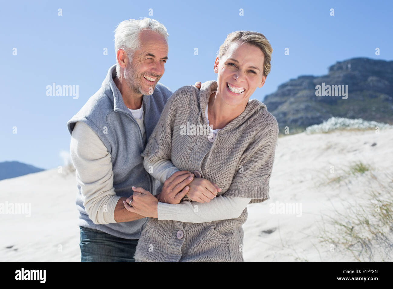 Attractive couple messing about on the beach Stock Photo