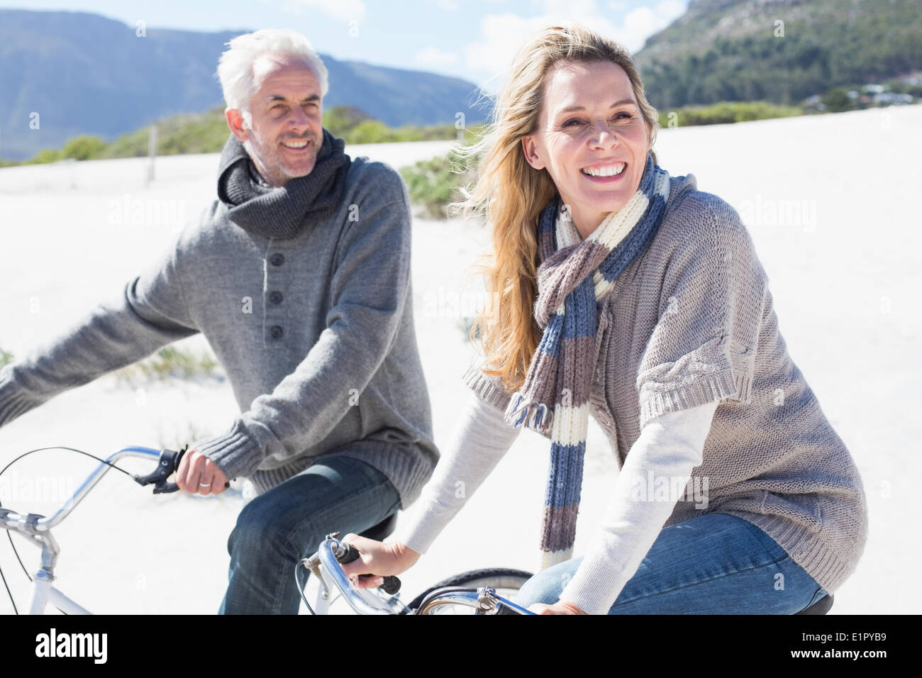 Carefree couple going on a bike ride on the beach Stock Photo