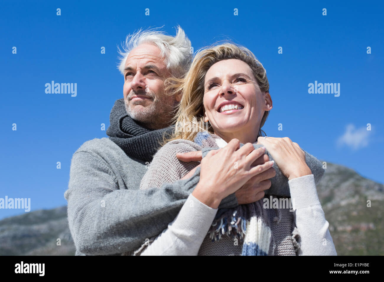Carefree couple hugging in warm clothing Stock Photo