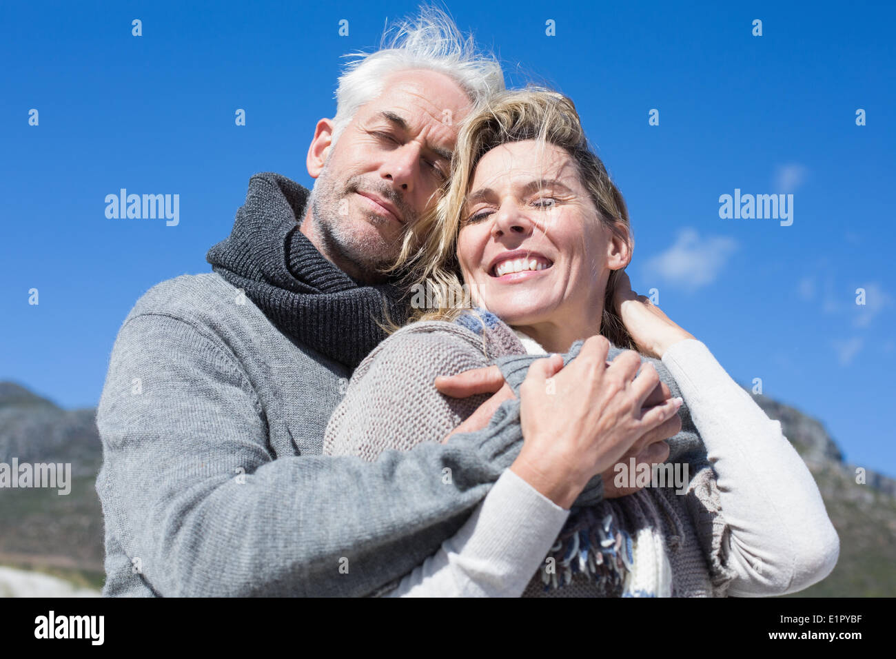 Carefree couple hugging in warm clothing Stock Photo