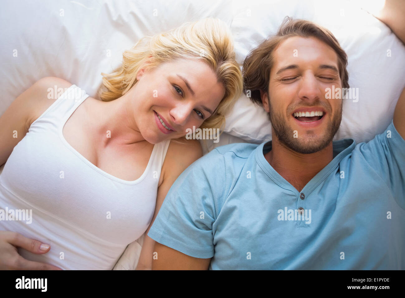 Happy couple relaxing on bed Stock Photo