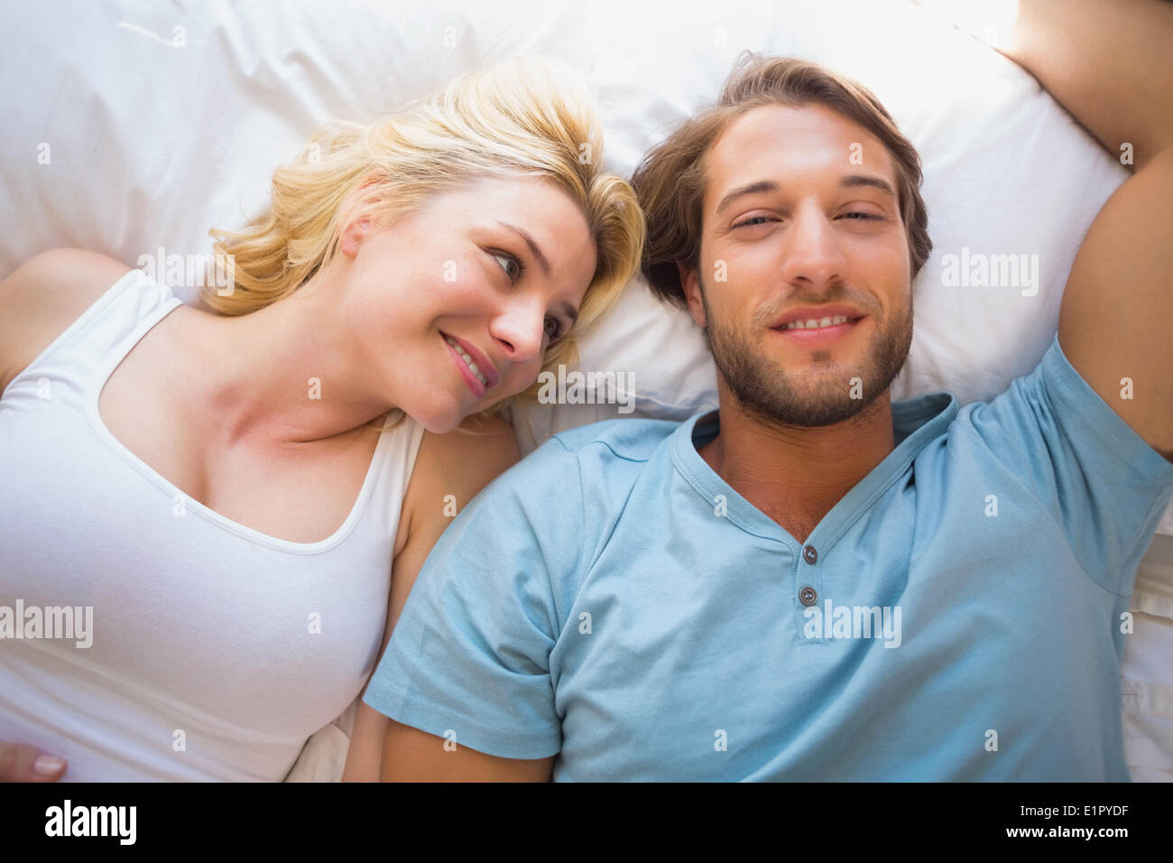 Happy couple relaxing on bed Stock Photo