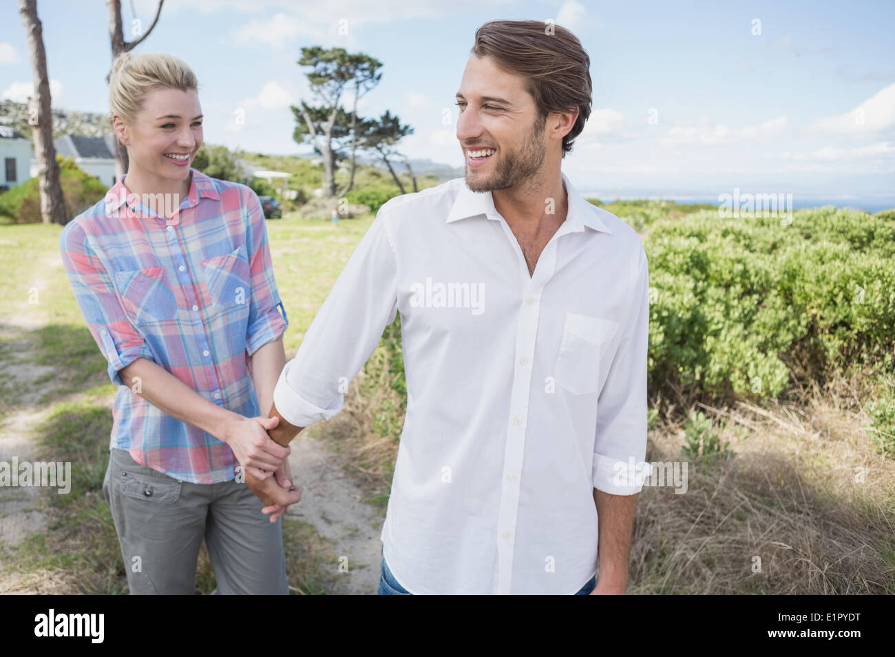 Happy couple walking holding hands Stock Photo