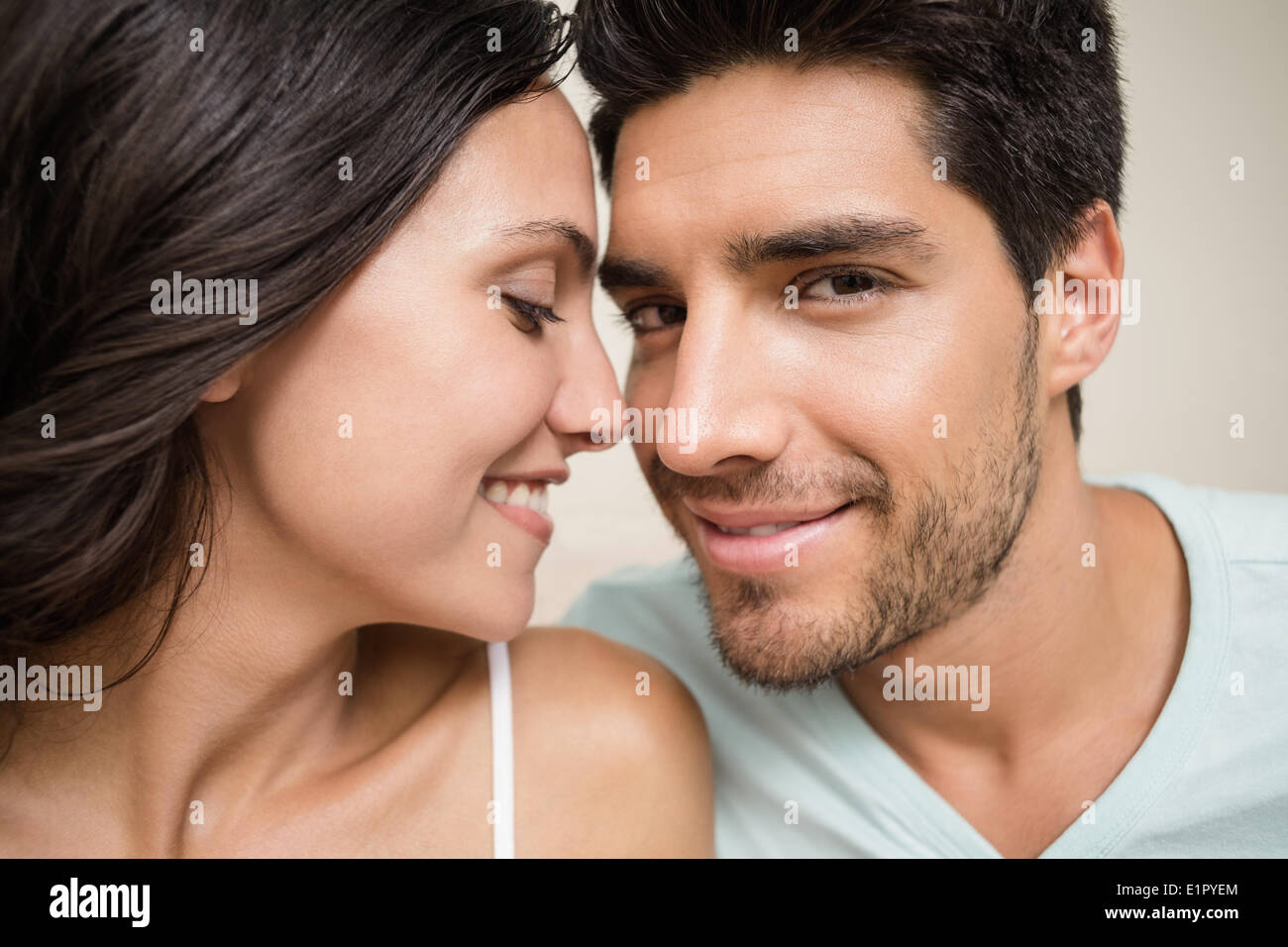 Attractive couple sitting on bed Stock Photo