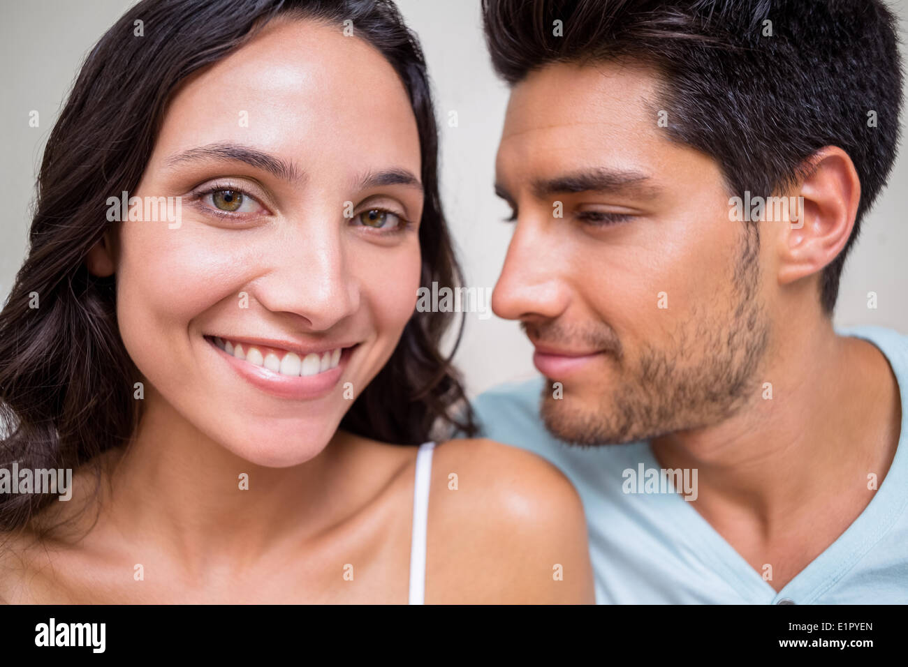 Attractive couple sitting on bed Stock Photo