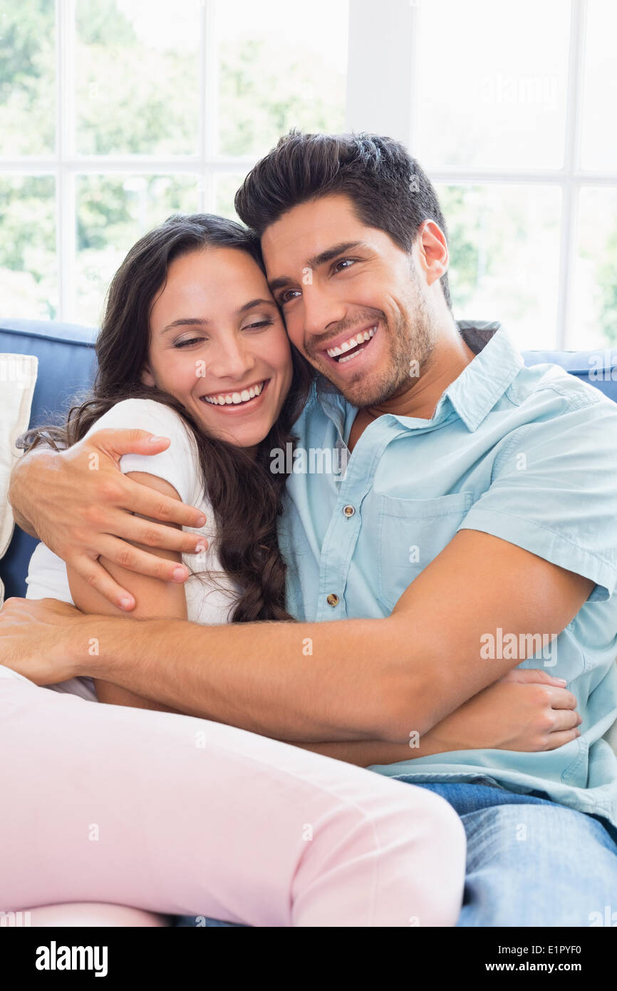 Attractive couple cuddling on the couch Stock Photo Alamy