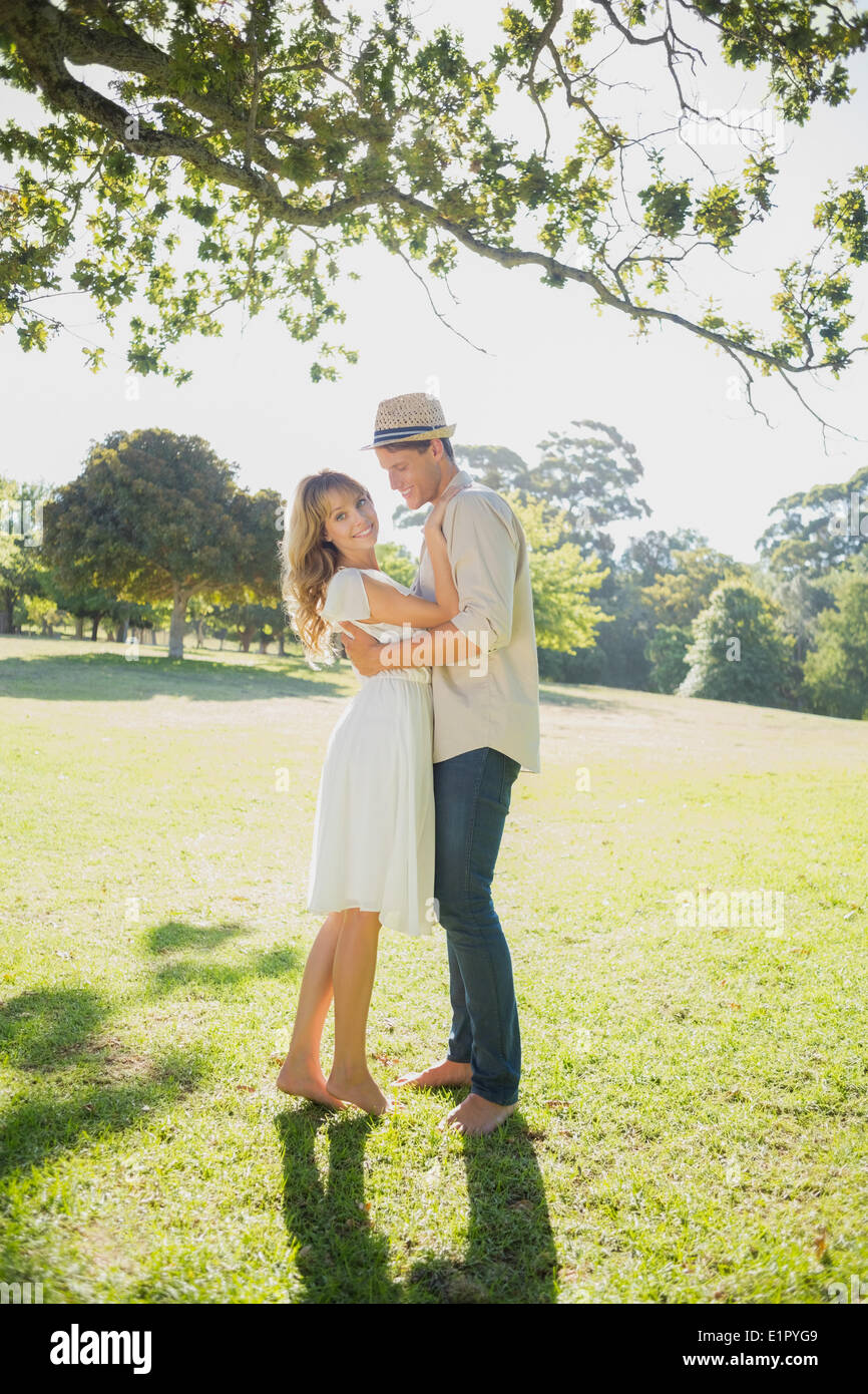 Cute couple posing in the park Stock Photo - Alamy