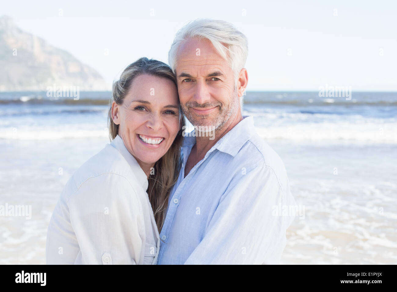 Happy couple hugging on the beach Stock Photo