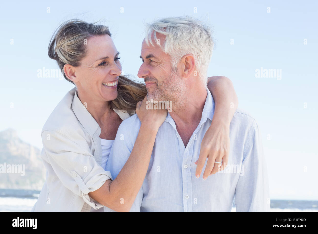 Attractive married couple hugging at the beach Stock Photo