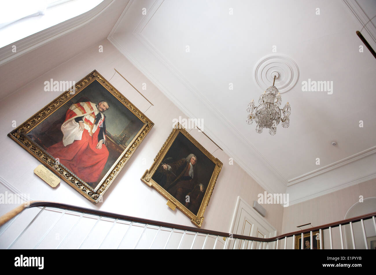 English country house interior stairs staircase with old master paintings on the walls Stock Photo