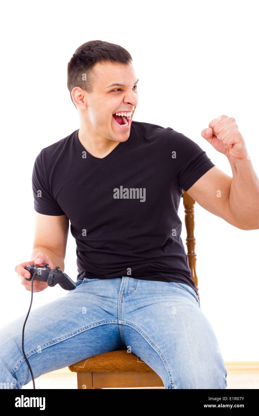 successful man sitting on chair playing computer game with joystick ...