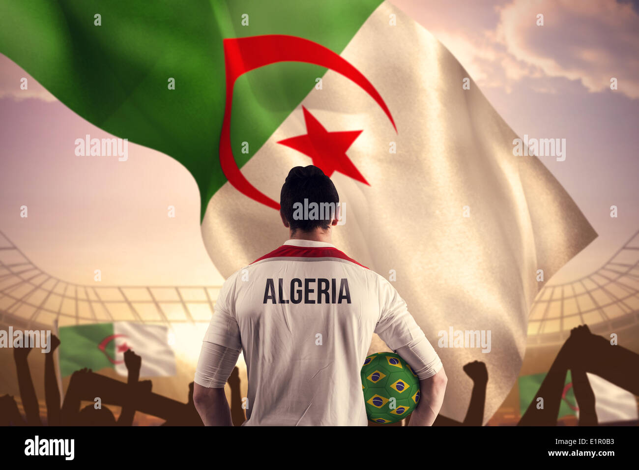 Composite image of algeria football player holding ball Stock Photo