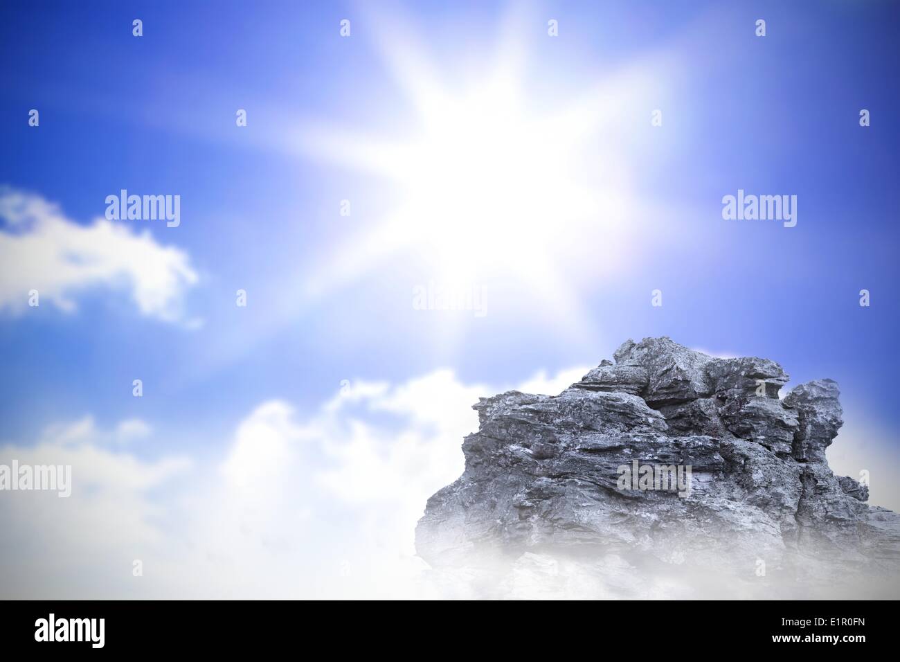 Large rock overlooking bright sky Stock Photo