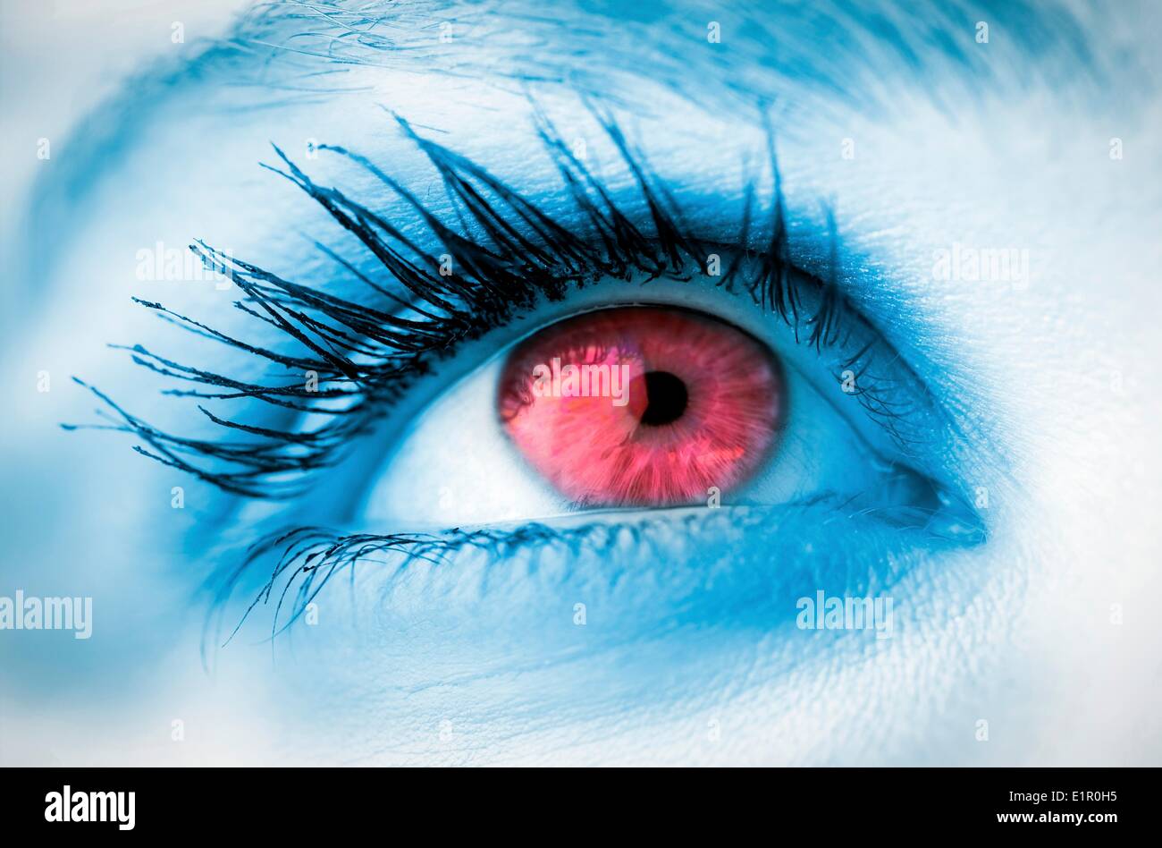 Red eye on blue face Stock Photo