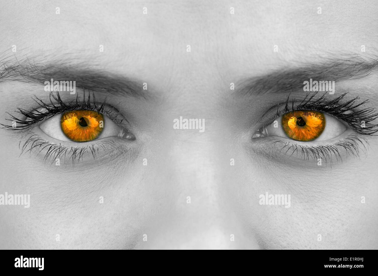Bright orange eyes on female face Stock Photo