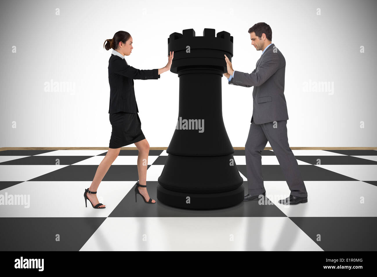Composite image of business people pushing chess piece Stock Photo