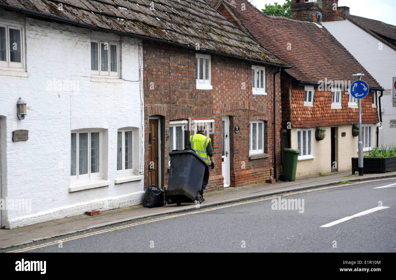 Billingshurst West Sussex UK - Refuse collector or dustman council working collecting rubbish from houses Stock Photo