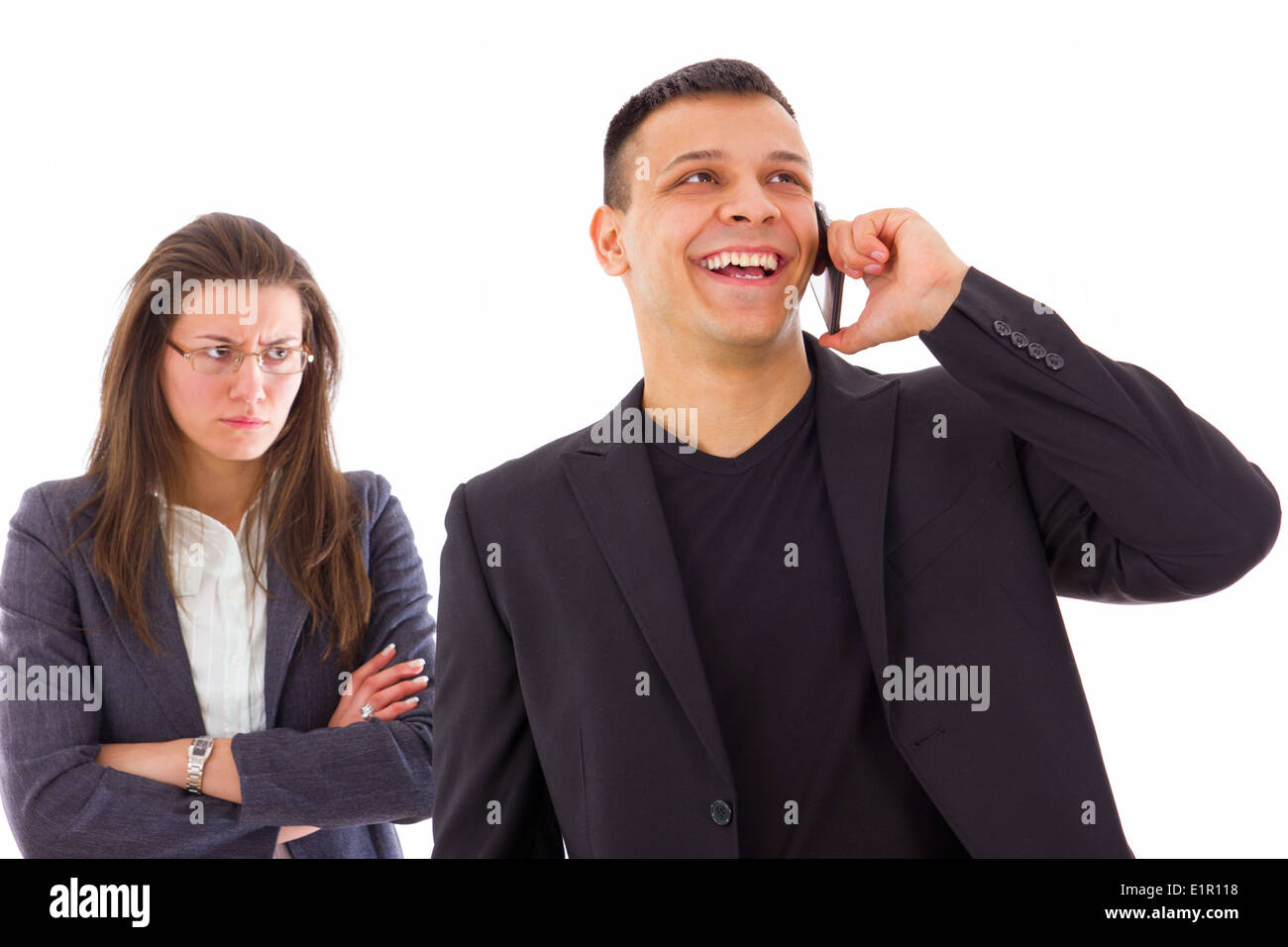 angry jealous woman suspecting on infidelity while her man is talking on the phone Stock Photo