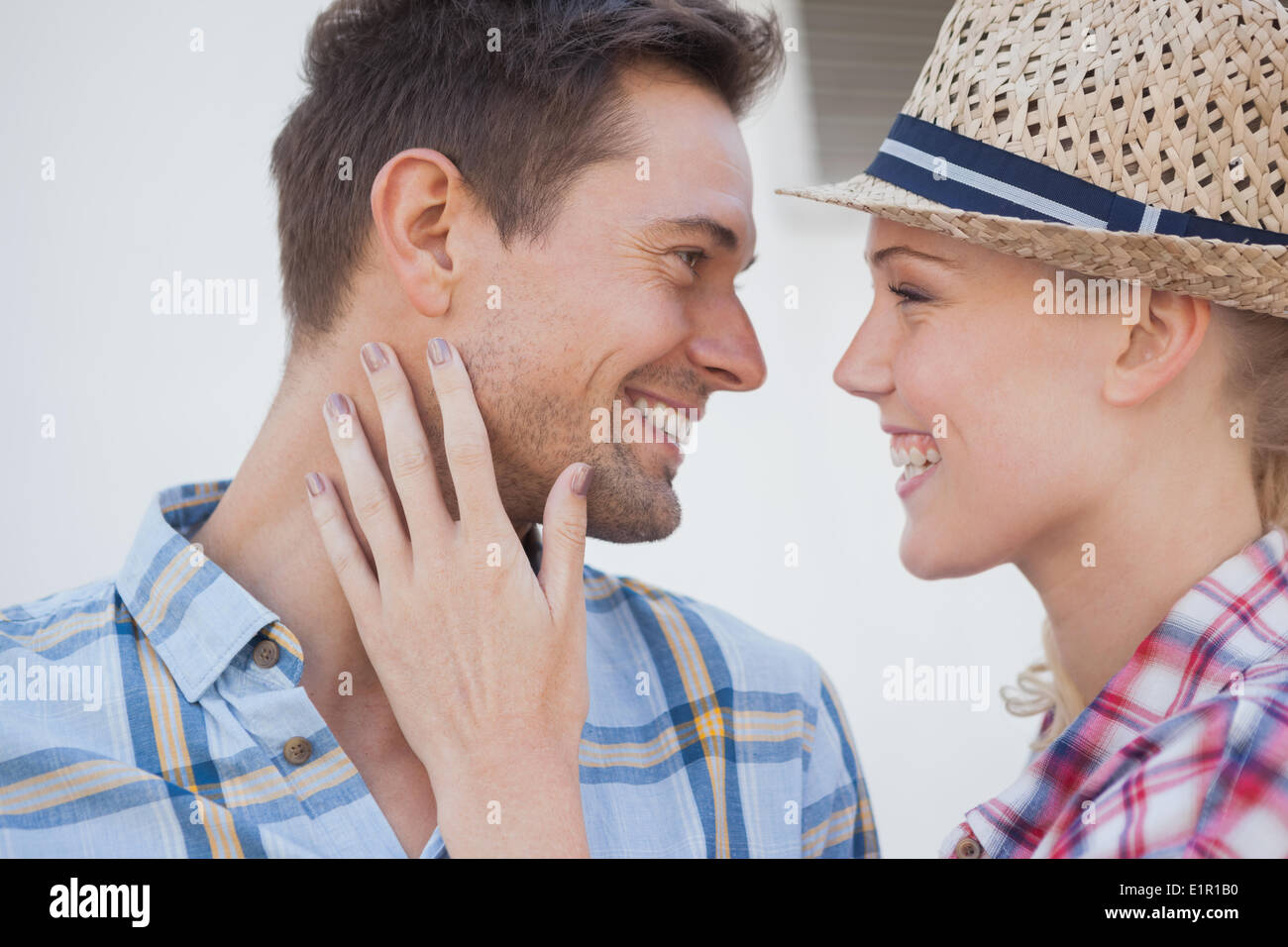 Young hip couple wearing check shirts facing each other Stock Photo
