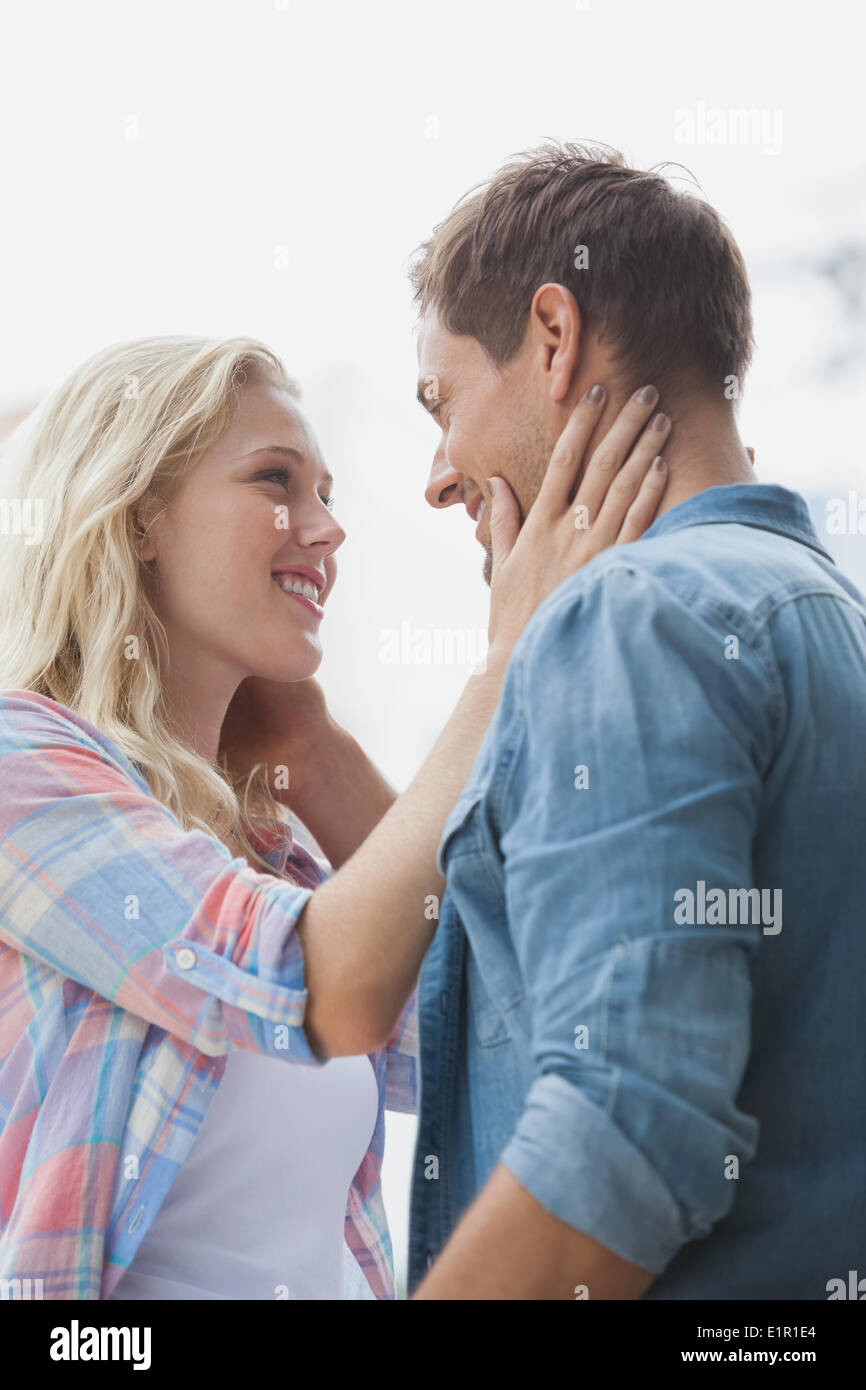 Cute young couple standing and facing each other Stock Photo