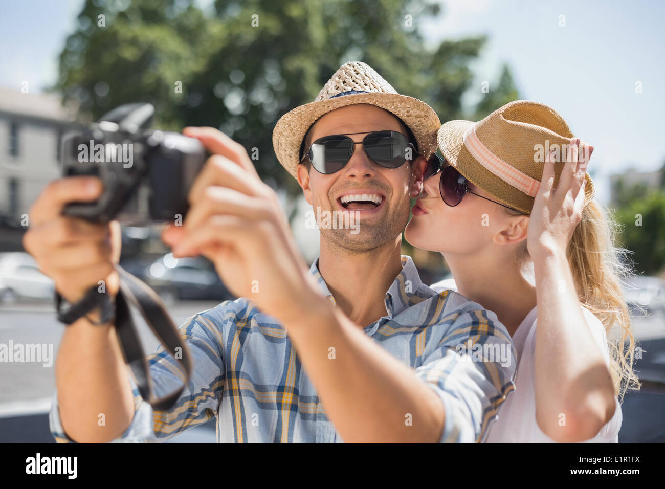 Hip young couple taking a selfie with camera Stock Photo