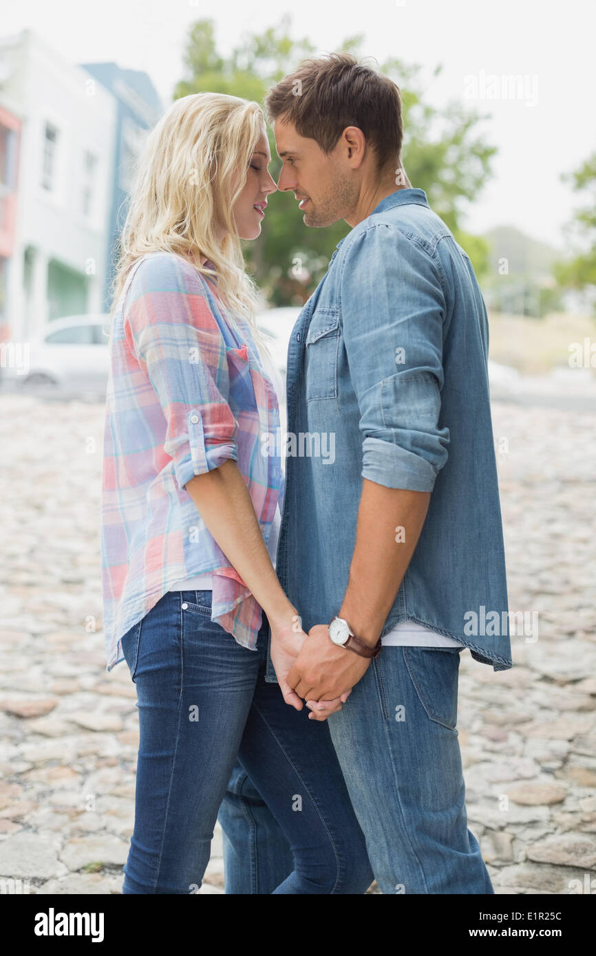Hip young couple about to kiss Stock Photo