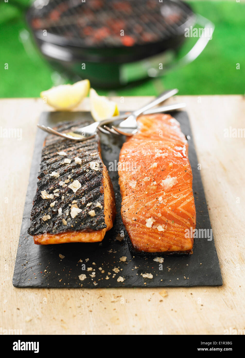Grilled salmon cooked on one side on the barbecue Stock Photo - Alamy