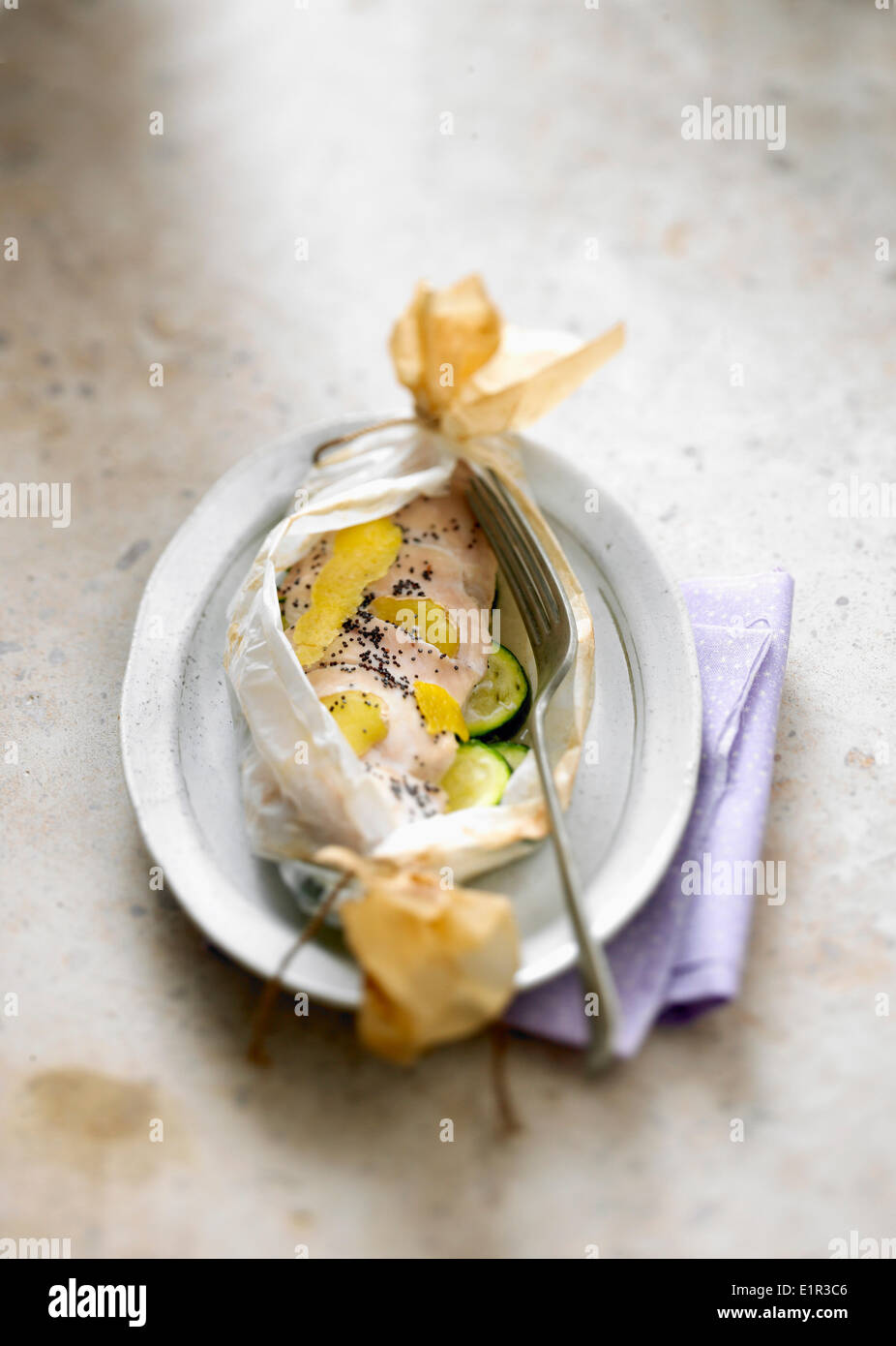 Chicken with poppy seeds cooked in wax paper Stock Photo