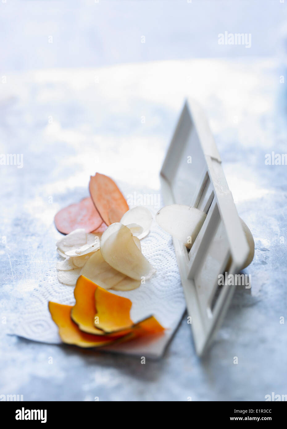 Thinl slicing vegetables with a mandoline Stock Photo
