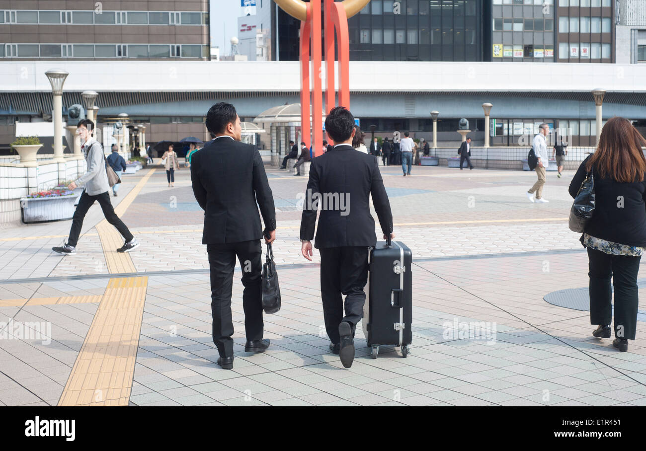 Tokyo, Japan 2014 - Two businessman walking on pedestrian area in Ueno district Stock Photo