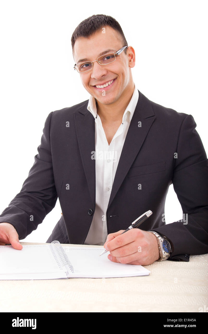 handsome businessman with glasses writing in notebook smiling Stock Photo