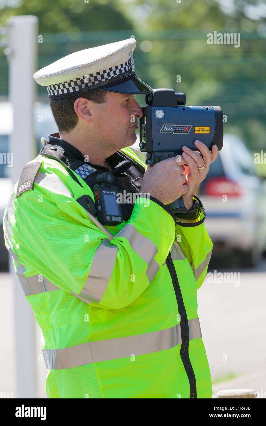 Police Officer Using A Handheld Radar Gun Stock Photo - Download