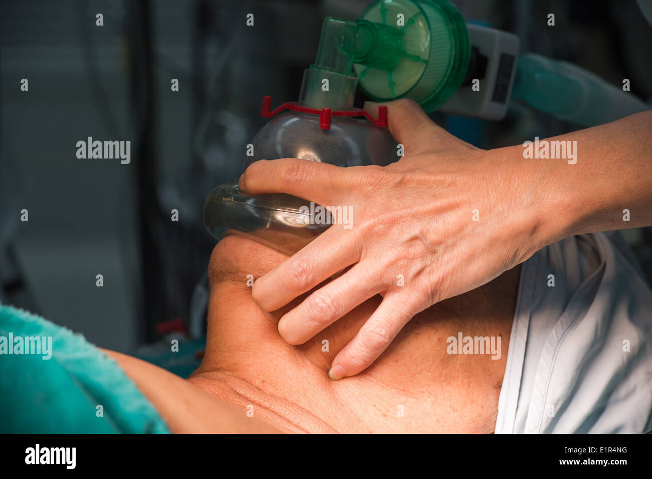 Pre oxygenation chin up position with holding oxygen mask Stock Photo