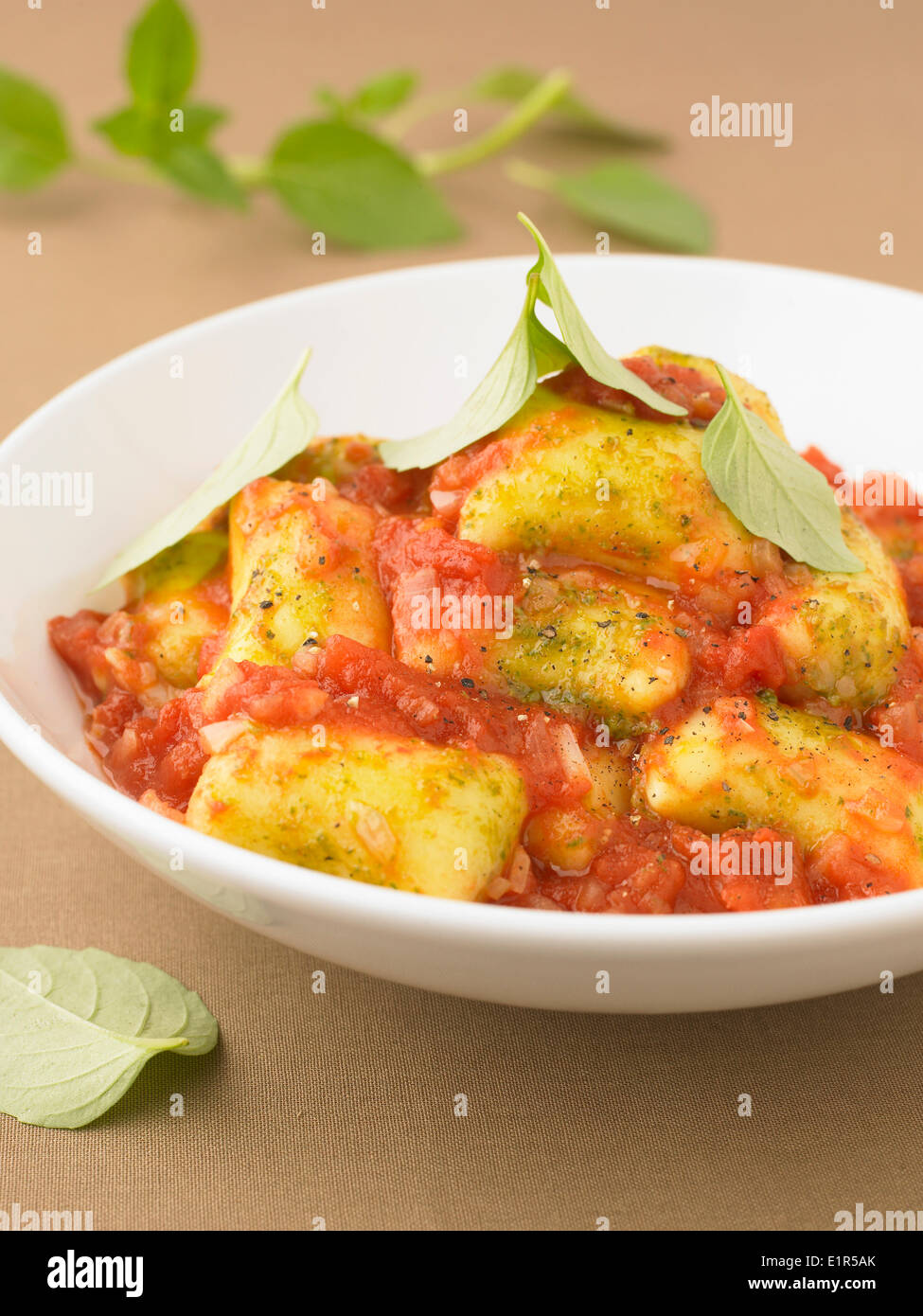 Gnocchis in tomato sauce with basil Stock Photo Alamy