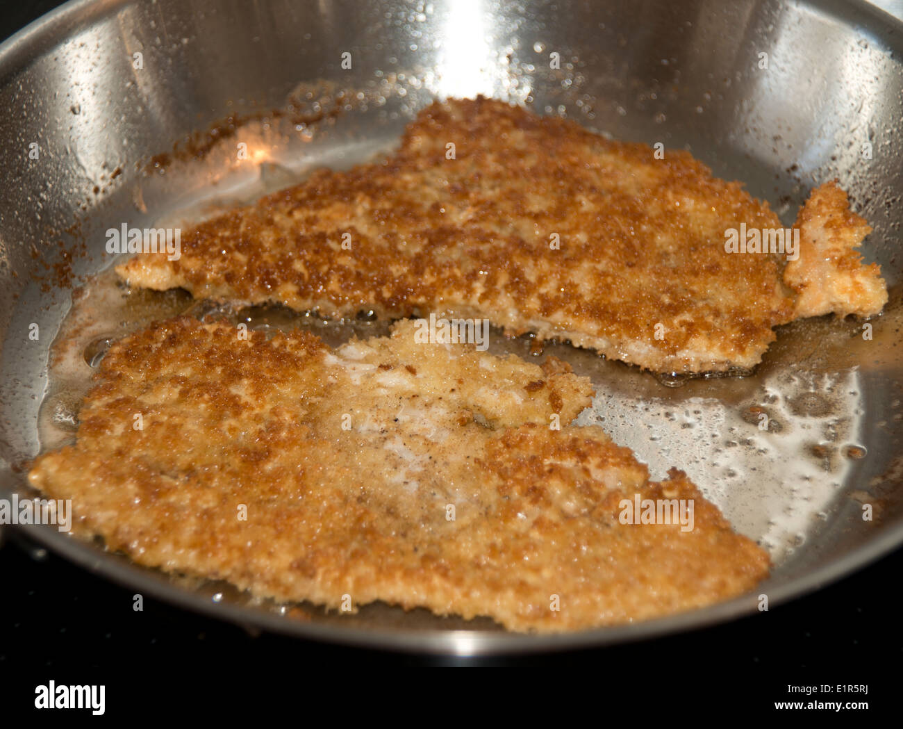 Breaded pork cutlets (Schnitzel) in frying pan Stock Photo Alamy