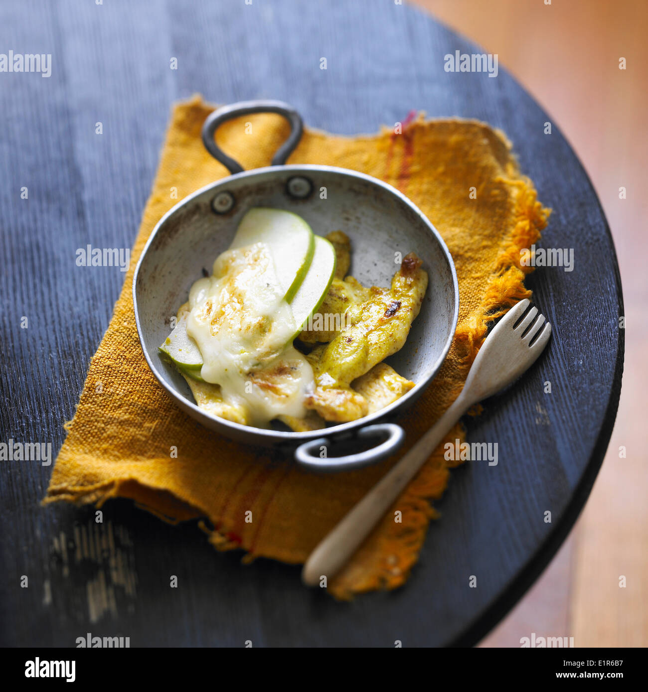Raclette with curried chicken and apples Stock Photo