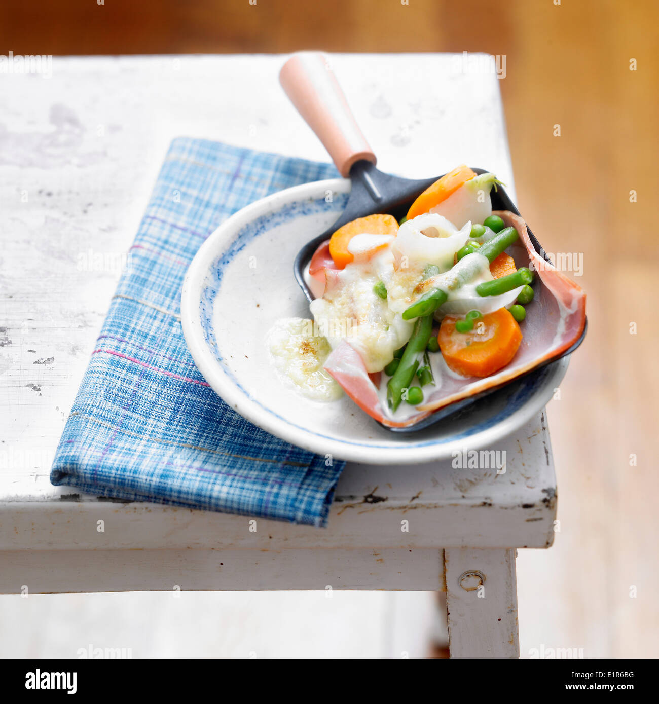 Raclette with spring vegetables Stock Photo